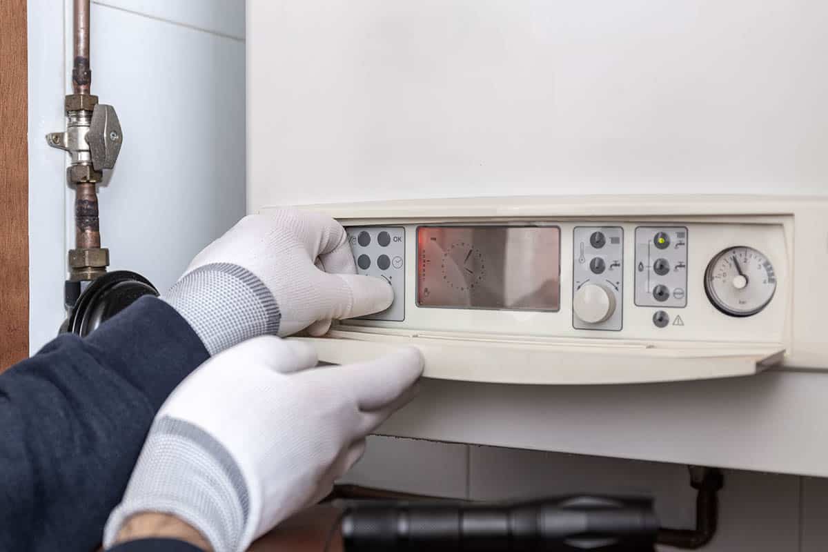 Technician servicing heating boiler in a house in Richmand upon Thames