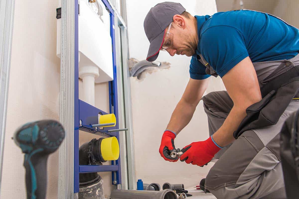 a plumber doing sanitary toilet plumbing in London