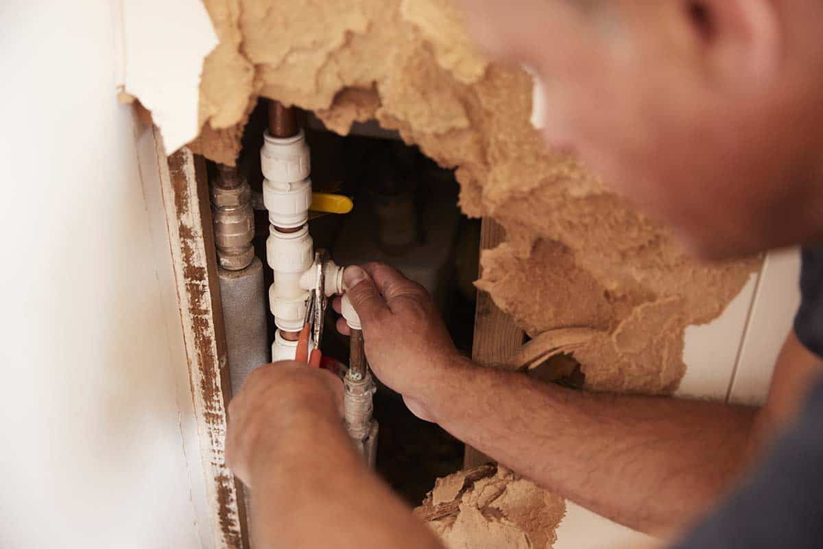 emergency plumber fixing a burst pipe in London