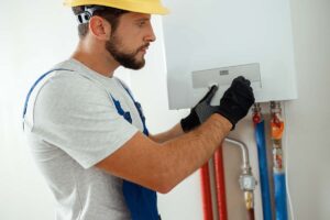 gas boiler engineer checking out a vaillant boiler